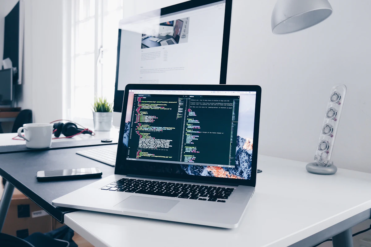 Developer workspace with multiple monitors and code on screen