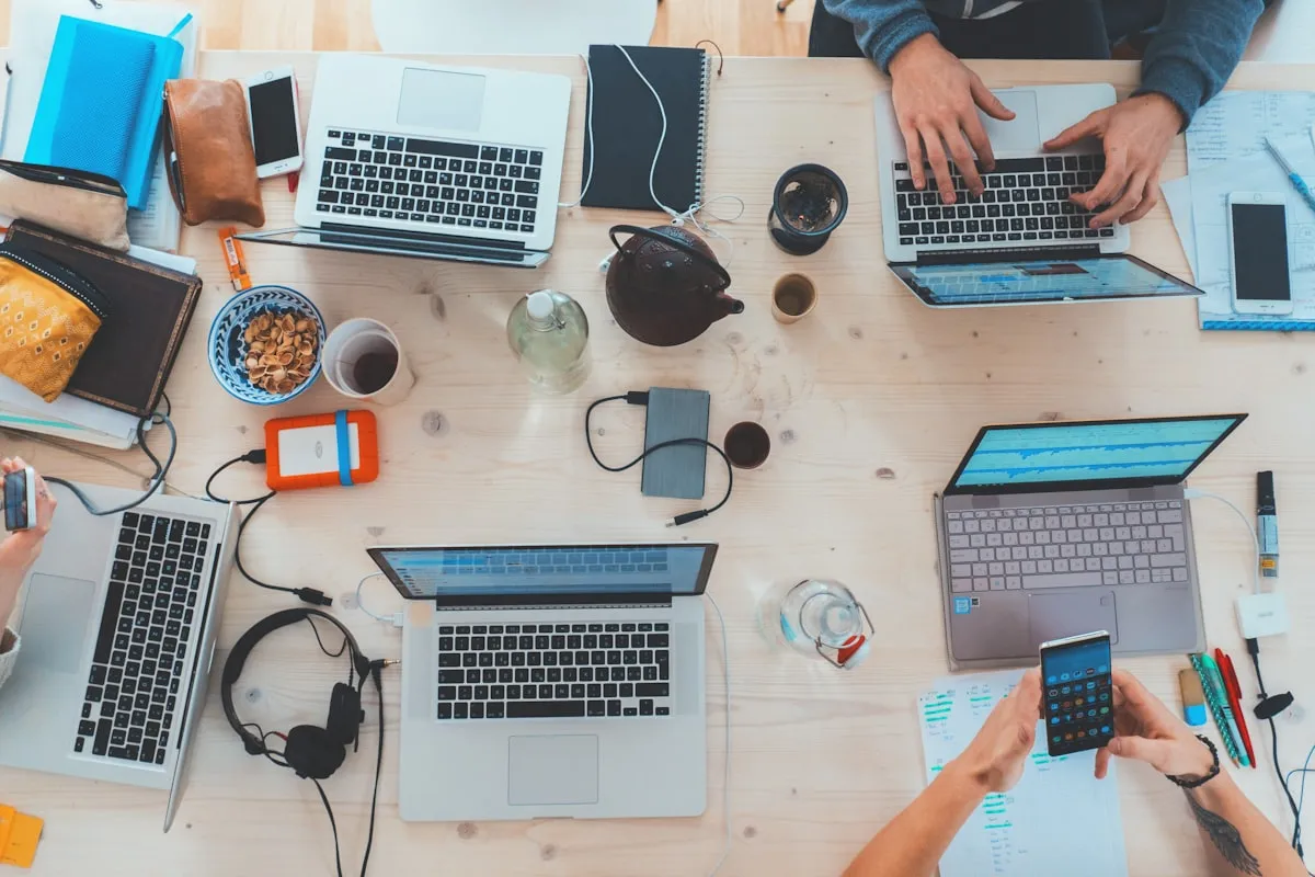 People working with focus in a modern workspace with laptops